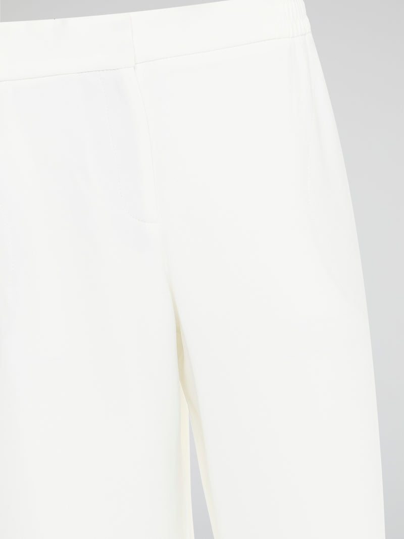 Introducing the ultimate embodiment of chic and comfort - the White Wide Leg Cropped Pants by Akris Punto. Crafted with meticulous attention to detail, these pants effortlessly blend sophistication and versatility, making them the perfect addition to any fashionista's wardrobe. Whether you're strolling on sandy beaches or attending a high-profile event, these pants will elevate your style game with their impeccable tailoring and striking silhouette.