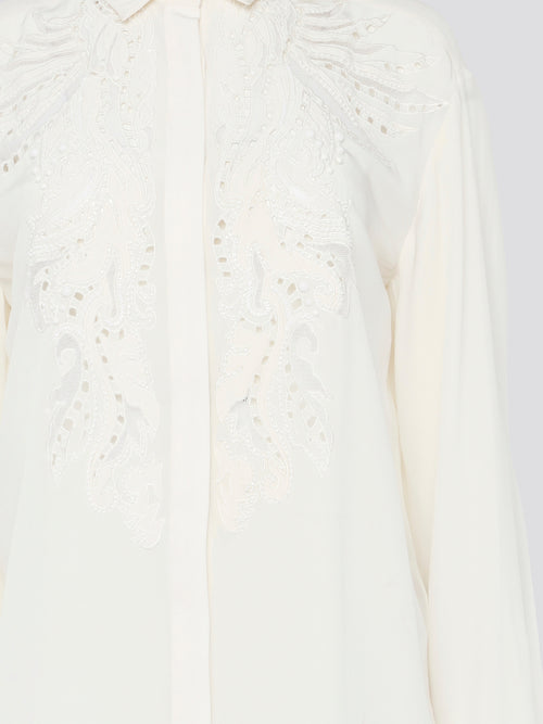 Feel like a bohemian queen in this exquisite white embroidered long sleeve blouse from Roberto Cavalli. The intricate detailing and luxurious fabric create a stunning and timeless piece that is perfect for any occasion. Elevate your wardrobe and make a statement with this elegant and unique blouse.