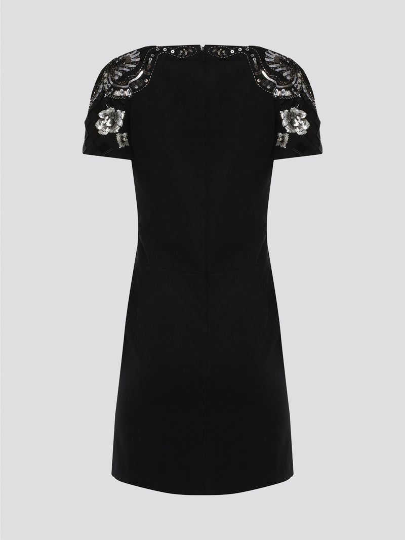 Step out in style and sophistication with our Black Embellished Plunge Dress by Roberto Cavalli. This stunning piece features intricate beadwork and shimmering embellishments that are sure to turn heads. The plunging neckline adds a touch of allure, making it the perfect choice for your next special occasion. Elevate your wardrobe with this show-stopping dress that exudes luxury and glamour.