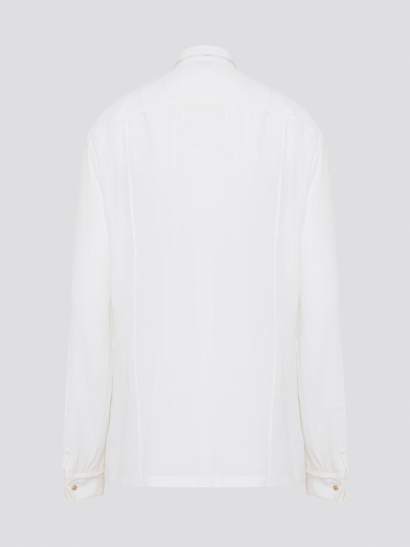 Elevate your wardrobe with this stunning Roberto Cavalli white detailed long sleeve shirt. Crafted with exquisite attention to detail, this shirt features intricate embroidery and embellishments that exude luxury and elegance. Perfect for adding a touch of sophistication to any ensemble, this statement piece is sure to turn heads wherever you go.